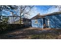 Backyard view of a blue home with a white door, window, and a wood fence at 884 Mcdaniel Sw St, Atlanta, GA 30310