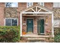 Close-up of a welcoming townhouse entrance with a covered porch and lush greenery at 2412 Peachwood Circle Northeast Ne Cir # 3, Atlanta, GA 30345