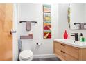 Modern bathroom featuring a floating vanity, stylish fixtures, and unique artwork at 3235 Roswell Ne Rd # 919, Atlanta, GA 30305