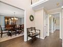 Hallway features a bench and gives way to the dining room and stairs to the second floor at 4324 Halifax Ne Ter, Roswell, GA 30075