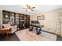Spacious home office with large built-in bookshelves, a ceiling fan, and a neutral color palette at 4324 Halifax Ne Ter, Roswell, GA 30075