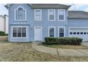 Two-story home with a blue facade, attached two-car garage and manicured front yard at 312 Jodeco Station E Cir, Stockbridge, GA 30281