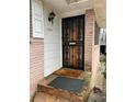 Classic home entrance featuring a decorative security door and a welcoming exterior light fixture at 1255 North Nw Ave, Atlanta, GA 30318