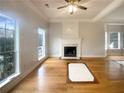 Spacious living room with fireplace, hardwood floors, and ample natural light at 4893 Hairston Pl, Stone Mountain, GA 30088