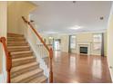 Spacious living room featuring hardwood floors, fireplace, and plenty of natural light at 6179 Bellewood Ash Ln, Tucker, GA 30084