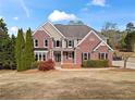 Charming two-story brick home with a well-manicured lawn and inviting front entrance at 410 Hickory Fairway Ct, Woodstock, GA 30188