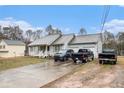 Exterior view of a cozy home featuring a long driveway and a spacious two-car garage at 160 Wesley Chapel Rd, Villa Rica, GA 30180