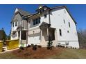 New two-story home with gray and white facade and two-car garage at 201 Retreat Ln, Canton, GA 30114