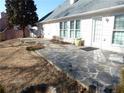 Flagstone patio featuring mature trees and a partially fenced yard at 735 Sunset Ridge Ln, Lawrenceville, GA 30045