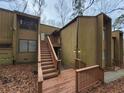 Two-story condo featuring wood siding and an elevated front entry with stairs at 5820 Par Four Ct, Lithonia, GA 30038