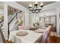 Formal dining room with elegant chandelier and view of the staircase at 950 Whitetail Ct, Alpharetta, GA 30005