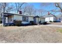 Lovely exterior elevation showing a charming single-story home with a screened-in porch on a sunny day at 127 Holly St, Social Circle, GA 30025
