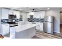 Modern kitchen with white cabinetry, stainless steel appliances, and a stylish island at 127 Holly St, Social Circle, GA 30025