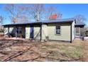 Shows the rear exterior with a small patio and tidy yard under a clear sky; note the well-maintained siding at 127 Holly St, Social Circle, GA 30025