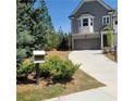Well-maintained front yard features lush greenery and a smooth, clean driveway at 203 Retreat Ln, Canton, GA 30114