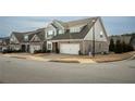 Street view of attractive townhomes featuring brick accents, two-car garages, and manicured lawns at 2101 Slick Stone Dr, Snellville, GA 30078