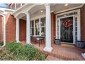 Inviting front porch with brick columns and seating area, perfect for enjoying the outdoors at 3388 Fieldwood Se Dr, Smyrna, GA 30080