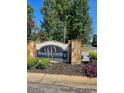 Stone sign for Woodlake Landing community surrounded by greenery at 8056 S Bay Ct, Riverdale, GA 30274