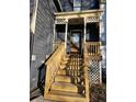 View of front porch with wooden stairs and decorative lattice at 8056 S Bay Ct, Riverdale, GA 30274