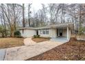 View of the home with a walkway leading to the front door and covered parking at 3511 Misty Valley Rd, Decatur, GA 30032