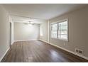 Bright living room featuring neutral paint, wood-look floors, and a large window that provides ample natural light at 3527 Glenview Sw Cir, Atlanta, GA 30331