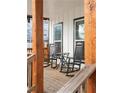 Cozy front porch featuring classic rocking chairs and rustic wood columns at 569 Hope Sw St, Atlanta, GA 30310