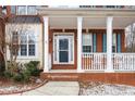 Inviting front porch with white columns and railing, leading to the front door at 130 Brookridge Ct, Fayetteville, GA 30215