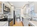 Modern kitchen with stainless steel appliances, white cabinets, and tile backsplash at 2184 Clairmont Ne Ter, Atlanta, GA 30345