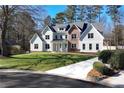 Expansive home with a large lawn and a paved driveway at 1601 Shadow Ct, Dunwoody, GA 30338