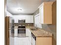 Modern kitchen featuring stainless steel appliances, granite countertops, and white cabinetry at 285 Argus Nw Cir, Atlanta, GA 30331