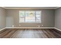 Bright living room with a large window and hardwood floors at 3111 Flat Shoals Rd, Decatur, GA 30034