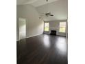 Spacious living room featuring a fireplace, hardwood floors, vaulted ceiling, and abundant natural light at 4976 Notting Glen Ln, Snellville, GA 30039