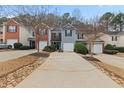 Townhome exterior showing the driveway and well maintained landscaping at 2724 Waverly Hills Dr, Lawrenceville, GA 30044