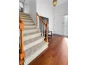 Bright entryway showcasing hardwood floors, a staircase, and a white front door at 3260 Henderson Mill Rd # A, Atlanta, GA 30341