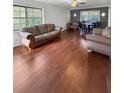 Spacious living room featuring hardwood floors, large windows, and stylish furniture at 3260 Henderson Mill Rd # A, Atlanta, GA 30341