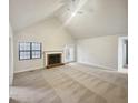 Bright living room featuring vaulted ceilings, fireplace, and neutral color palette at 180 Antebellum Way, Fayetteville, GA 30215
