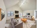 Bright living room featuring vaulted ceilings, fireplace, and neutral color palette at 180 Antebellum Way, Fayetteville, GA 30215