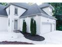 Charming exterior featuring a three-car garage, manicured landscaping, and stone accents at 3258 Bransley Way, Duluth, GA 30097
