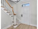 Inviting foyer showcasing the staircase with carpeted steps and a white front door for a classic look at 1160 Windsor Pkwy # 13, Atlanta, GA 30319