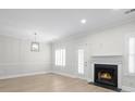 Cozy living room features wood floors, a fireplace, and natural light, creating a warm atmosphere at 1160 Windsor Pkwy # 13, Atlanta, GA 30319