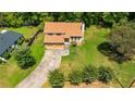 Inviting home featuring a two-car garage, manicured lawn, and mature trees for added privacy at 4090 Welcome All Ter, Atlanta, GA 30349