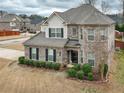 Charming two-story brick home with a turret, well-kept lawn and professional landscaping at 600 Lockerbie Ter, Mcdonough, GA 30252