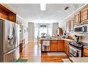 Well-lit kitchen featuring stainless steel appliances and wooden cabinetry at 1137 Maple Creek Rdg, Loganville, GA 30052