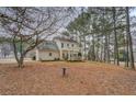 Large backyard with a patio area and a pergola, surrounded by mature trees for privacy at 500 Nicole Se Ct, Conyers, GA 30094