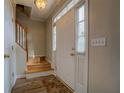 Inviting foyer featuring a white front door, hardwood floors, and staircase at 500 Nicole Se Ct, Conyers, GA 30094