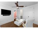 Bright office space with hardwood floors, TV, designer desk, and adjacent bathroom access at 304 Stonemont Dr, Atlanta, GA 30305