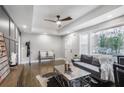 Stylish living room featuring hardwood floors, tray ceiling, and lots of natural light at 1459 Kenilworth Sw Dr, Atlanta, GA 30310