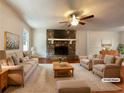 Bright living room with a stone fireplace, plush furniture, and a cozy rug for comfortable living at 7330 White Flag Trl, Lithia Springs, GA 30122