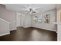 Bright living room features hardwood floors, neutral paint, and large windows that offer ample natural light at 131 Ellis Dr, Conyers, GA 30012