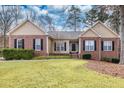 Lovely brick and siding home featuring manicured landscaping and a welcoming entrance at 1688 Vinings Ct, Lawrenceville, GA 30043